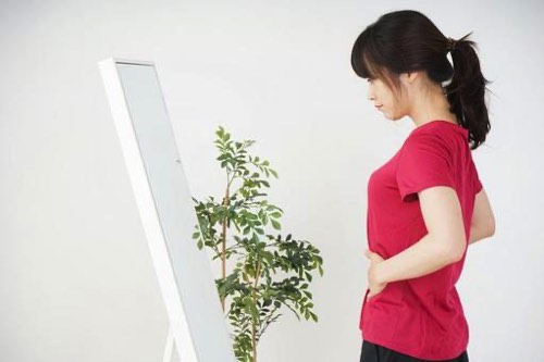 お腹を気にする女性