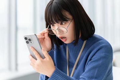 スマートフォン通信障害に驚く女性