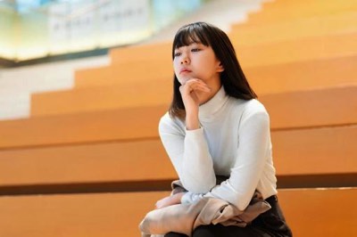 椅子に座って考える女性